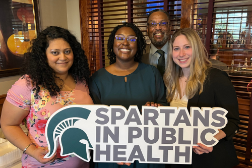MPH graduates holding a 'spartans in public health' sign