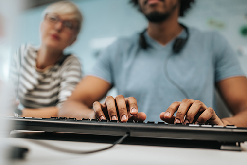 Man typing on keyboard