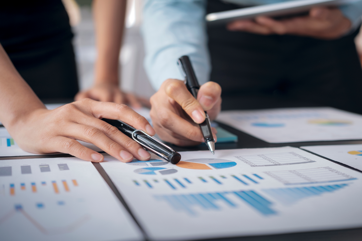 People reviewing charts and tables